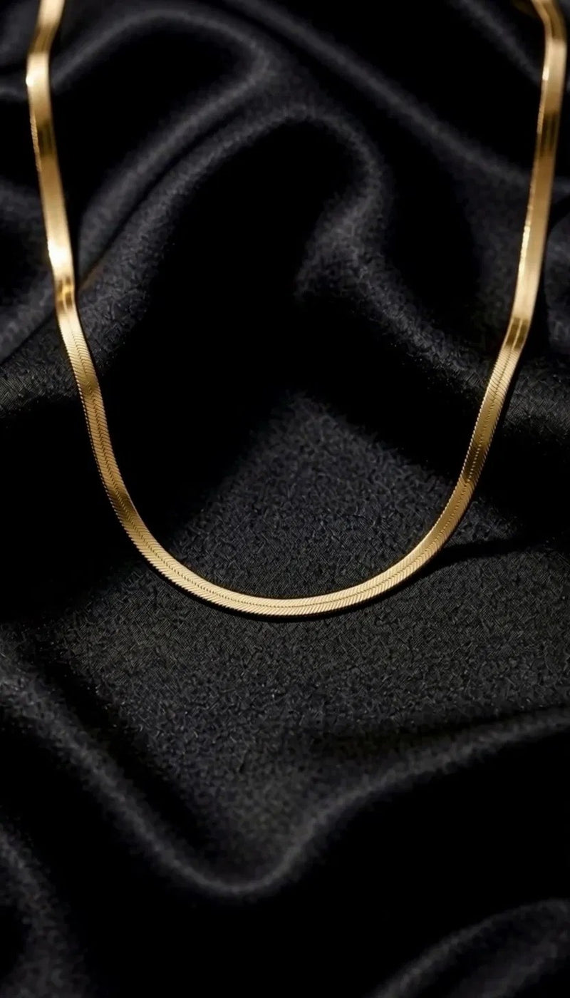The Signature Chain draped on black satin