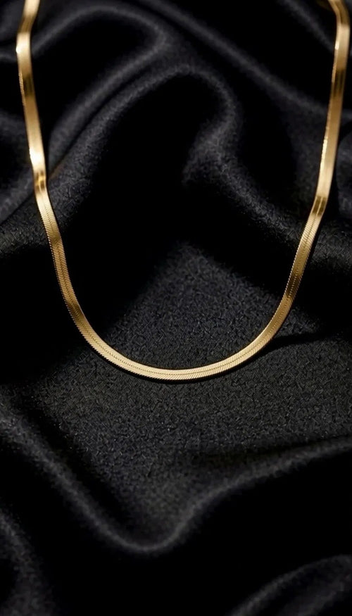 The Signature Chain draped on black satin