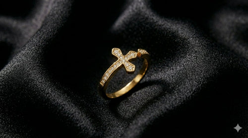 The Meridian Ring, a gold cross ring with pavé stones, on black satin