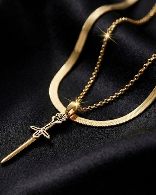 The Vanguard Pendant layered with a herringbone chain on black satin